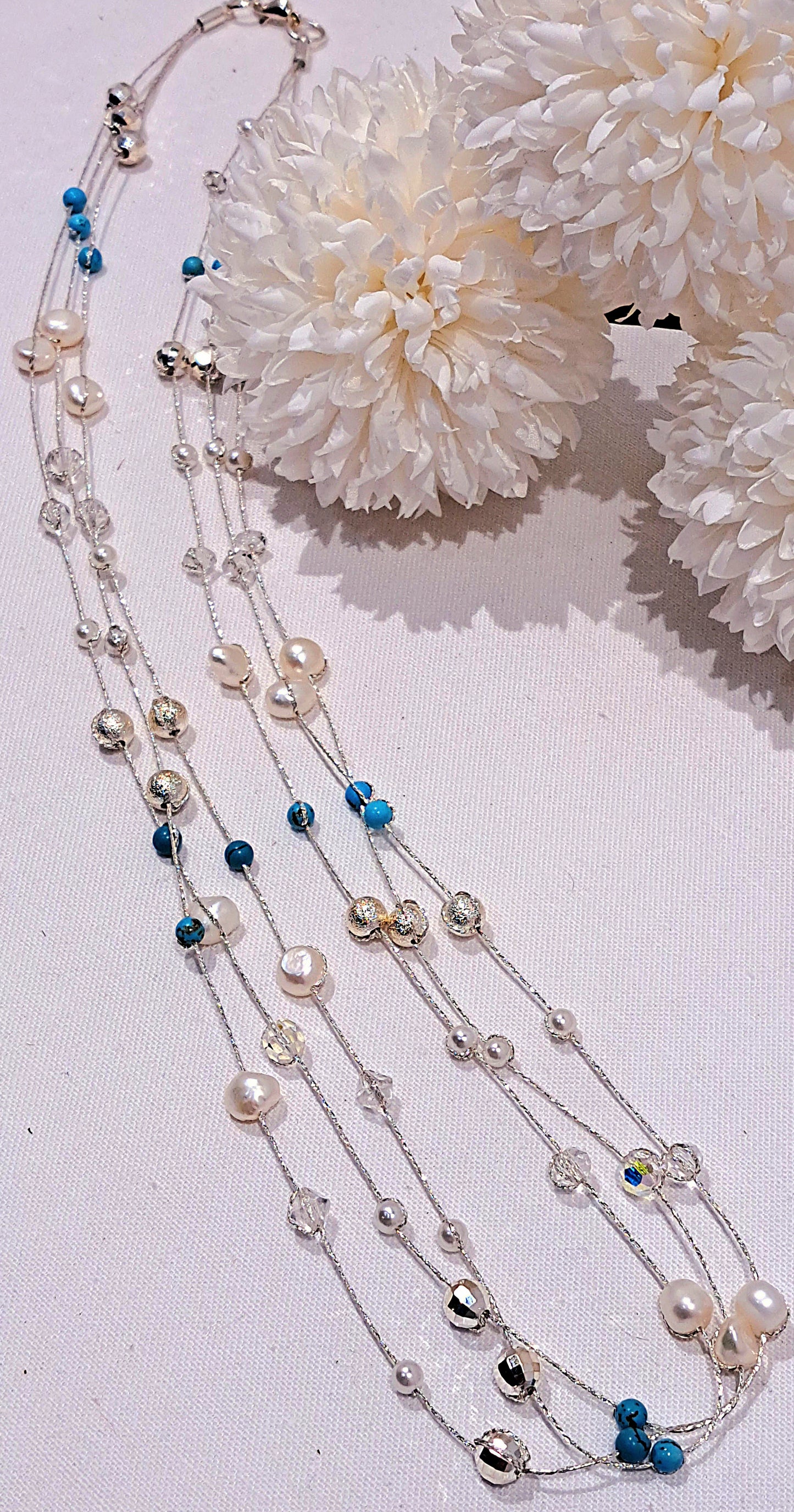 Ladies silver three strand string and bead necklace.