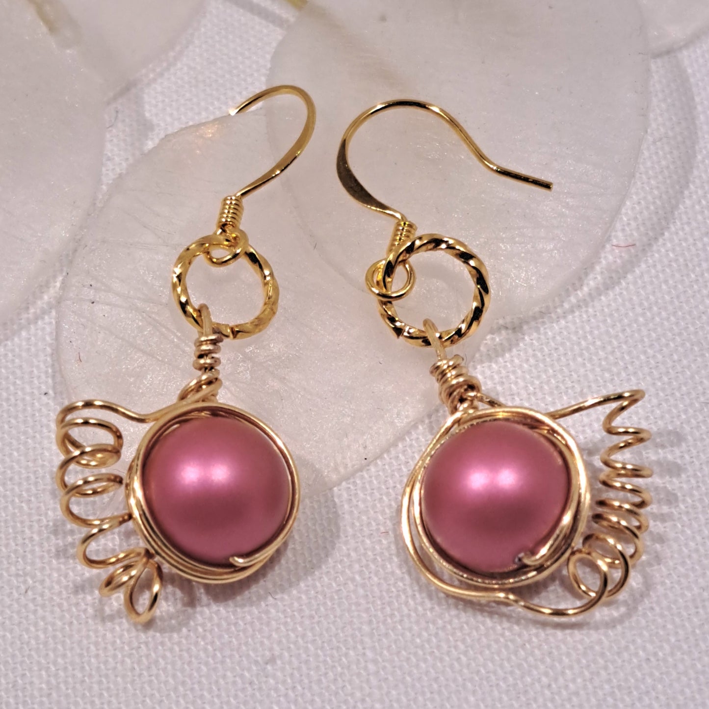 Swarovski bright pink pearl earrings wire wrapped in gold.