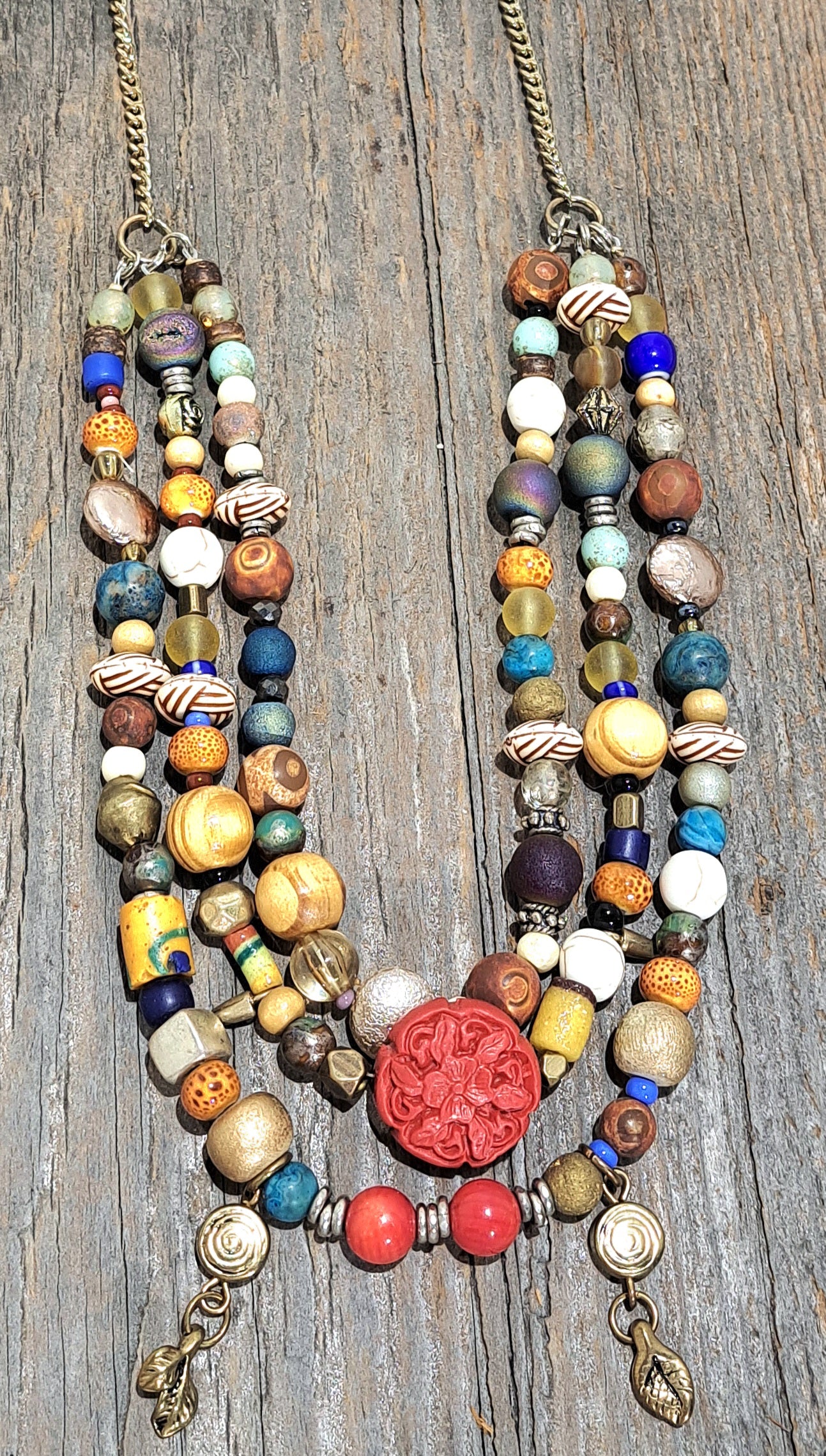 Triple strand multibead necklace on brass chain.