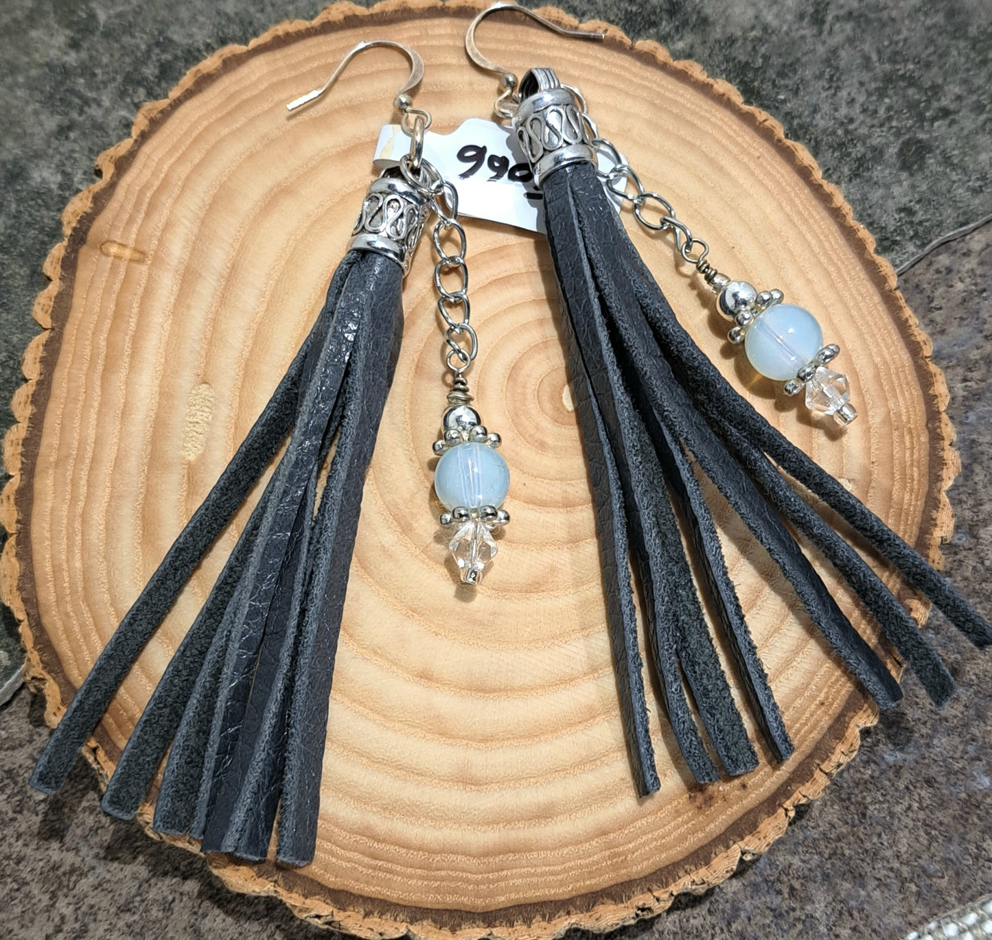 Ladies grey leather tassel earrings with chain and opaque glass balls.
