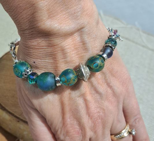 Ladies bracelet of blue/green recycled African glass and leaf focal.