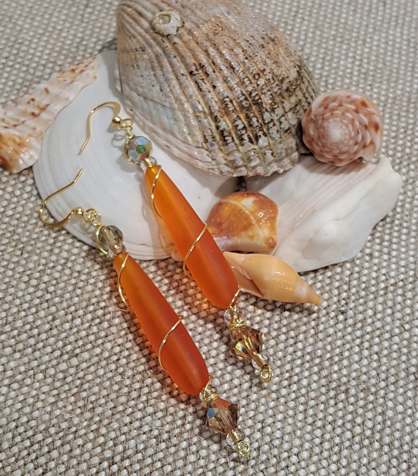 Ladies orange sea glass wire wrapped earrings.