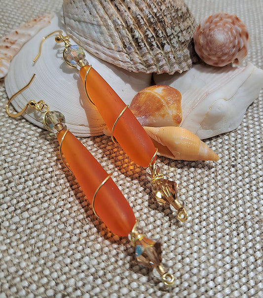Ladies orange sea glass wire wrapped earrings.