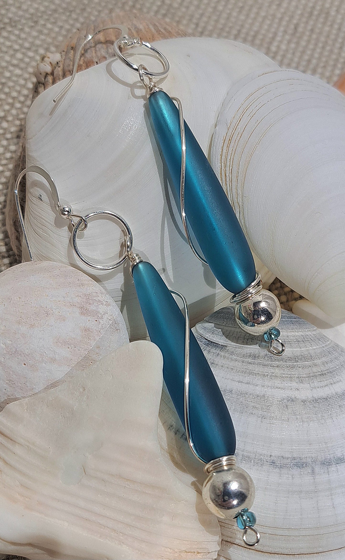 Ladies blue Sea glass drop earrings with silver wire wrapping.