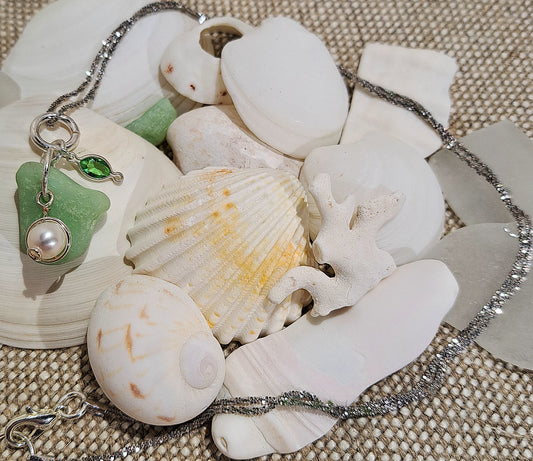 Ladies sterling silver necklace with pale green sea glass and hanging pearl and charm.
