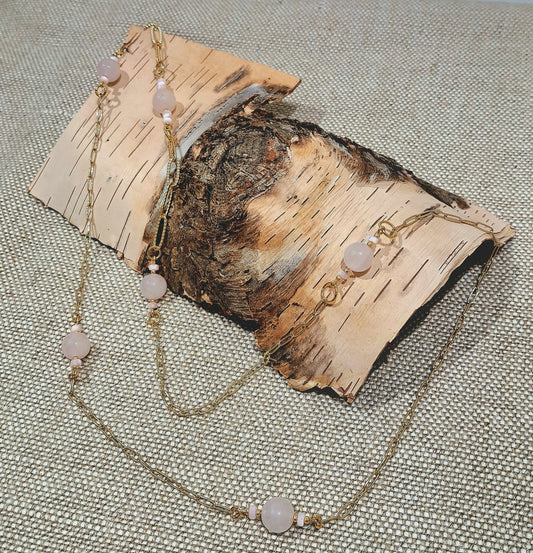 Ladies necklace with Rose Quartz beads suspended amongst gold plated paperclip style chain.