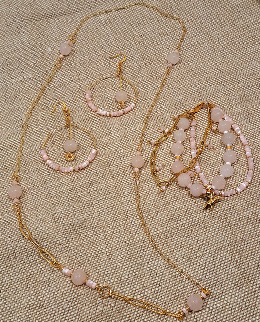 Ladies gold hoop earrings with pink quartz and pink mother of pearl.