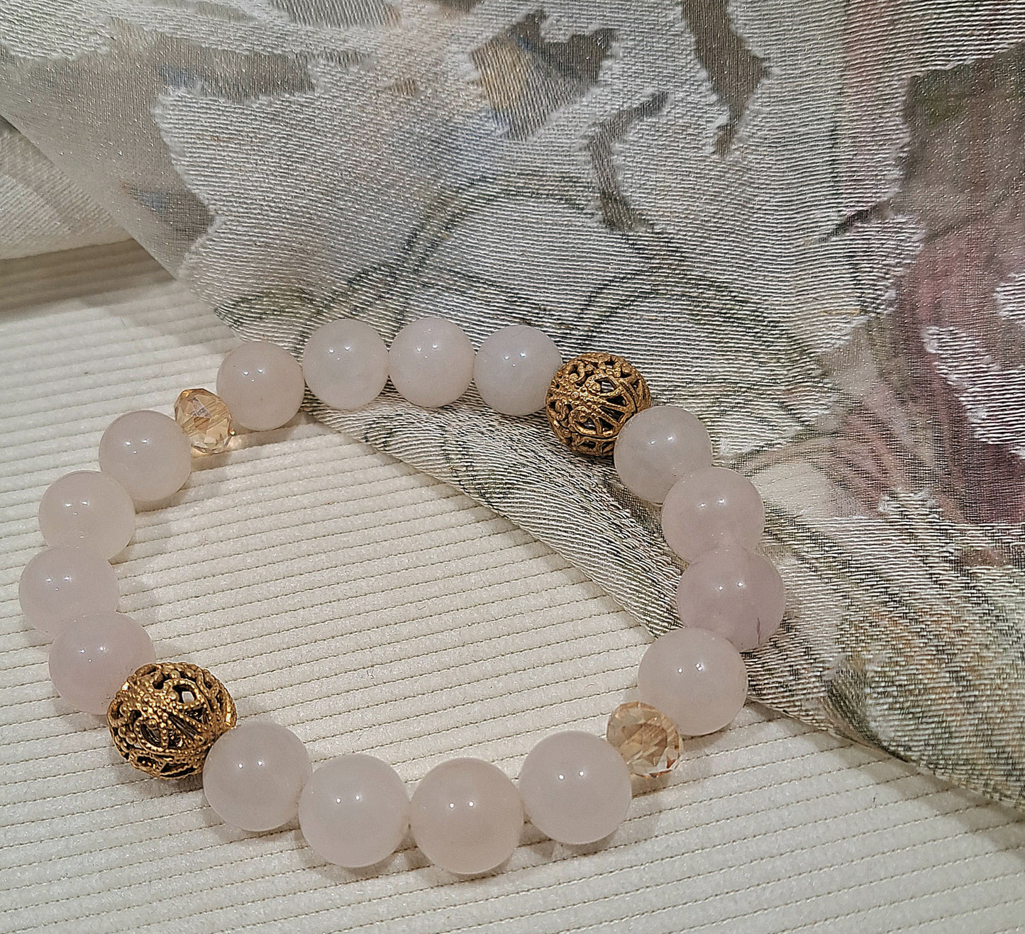 Ladies stretch Rose Quartz with Vintage gold filigree accents.