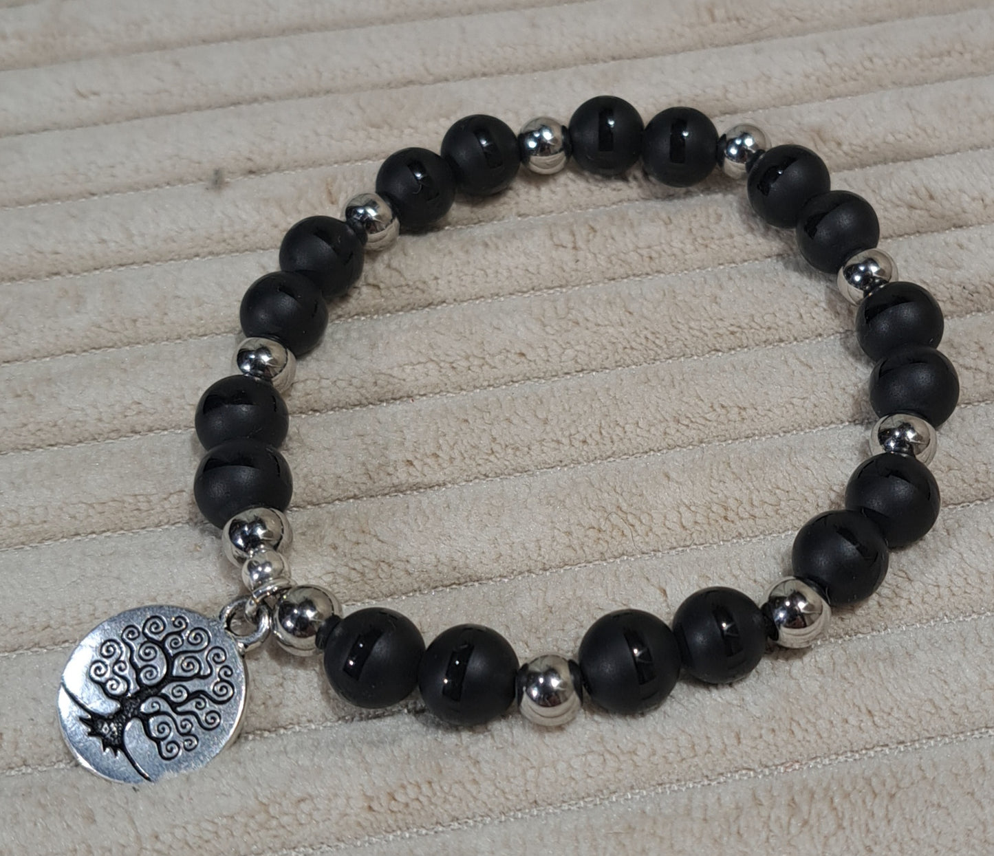 Unisex Tree of Life stretch bracelet of striped Black Onyx and Steel spacers.