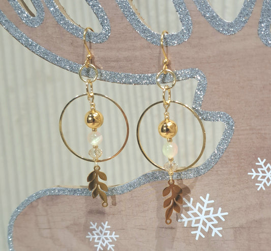 Ladies Gold hoops with Selenite and gold dangle beads and leaf motif.