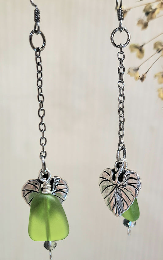 Stainless Steel dangle earrings with green glass and leaf charm.