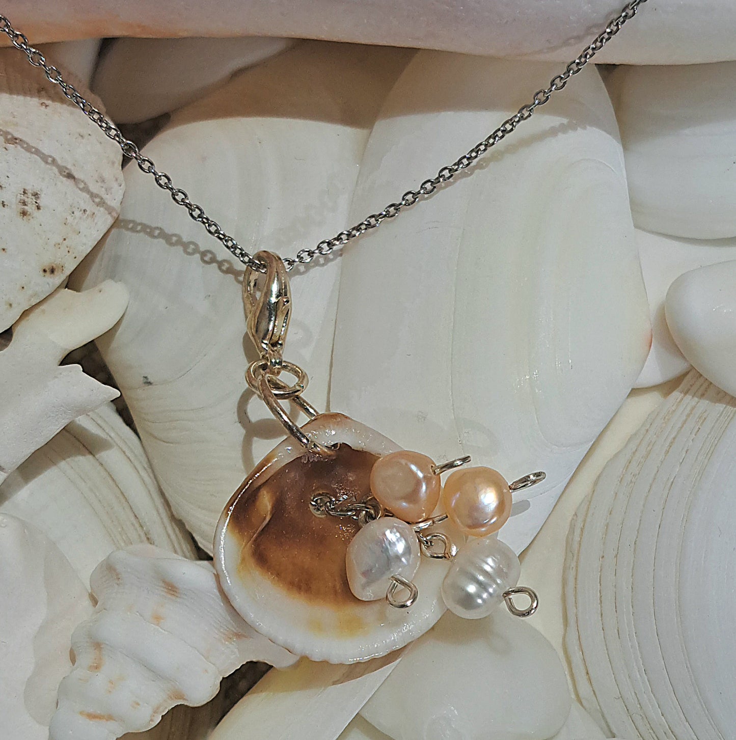 Sea Glass Shell pendant on gold chain with ivory and peach fresh water pearl dangles.