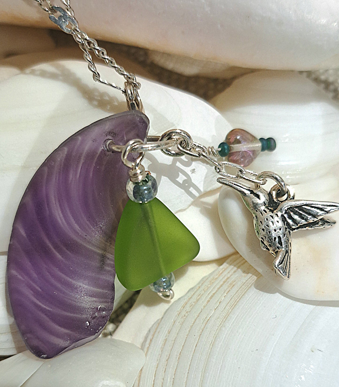 Hummingbird Charm and Purple strie Sea Glass necklace.
