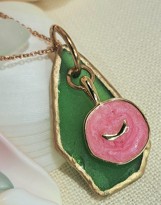 Green Sea Glass pendant necklace with pink whale tail charm.