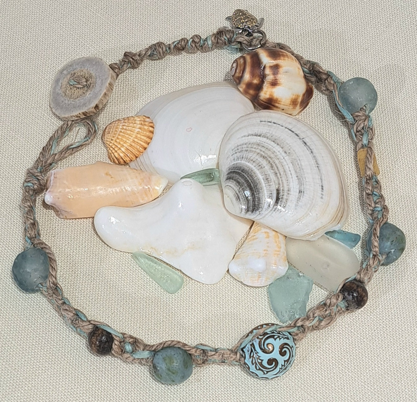 Jute double wrap bracelet with blue African glass, wood, and large metal focal bead.