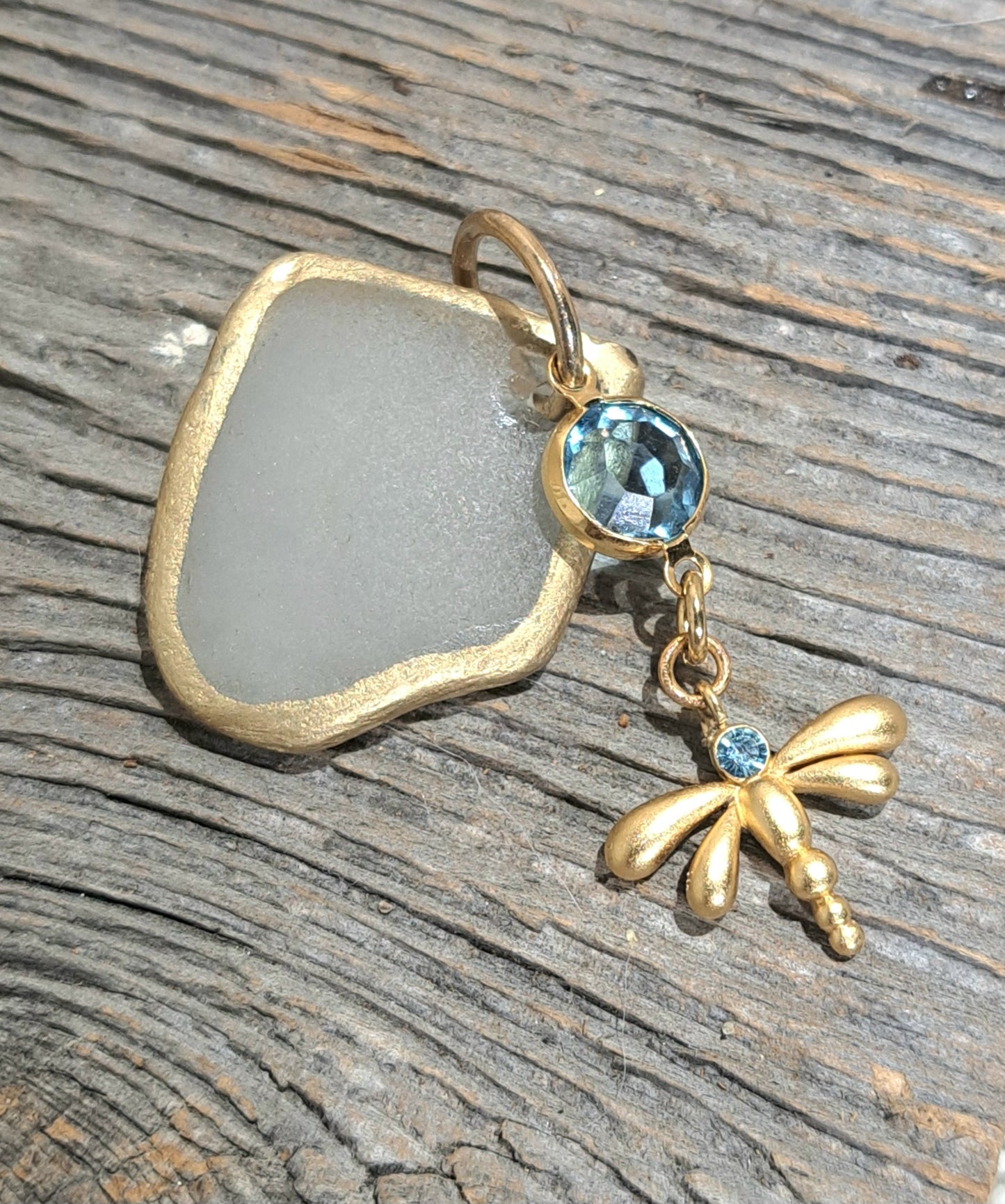 Clear Sea Glass Gold Foil pendant with blue glass charms on gold cable chain.