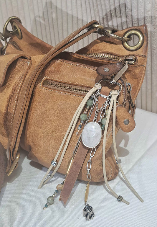Distressed brown leather bag charm with large ivory quartz focal .