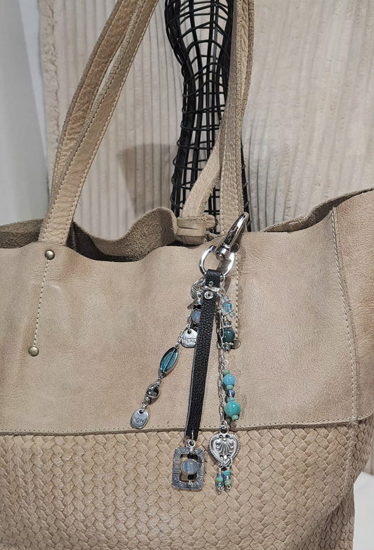 Black leather ,steel and blue resin beaded bag charm .