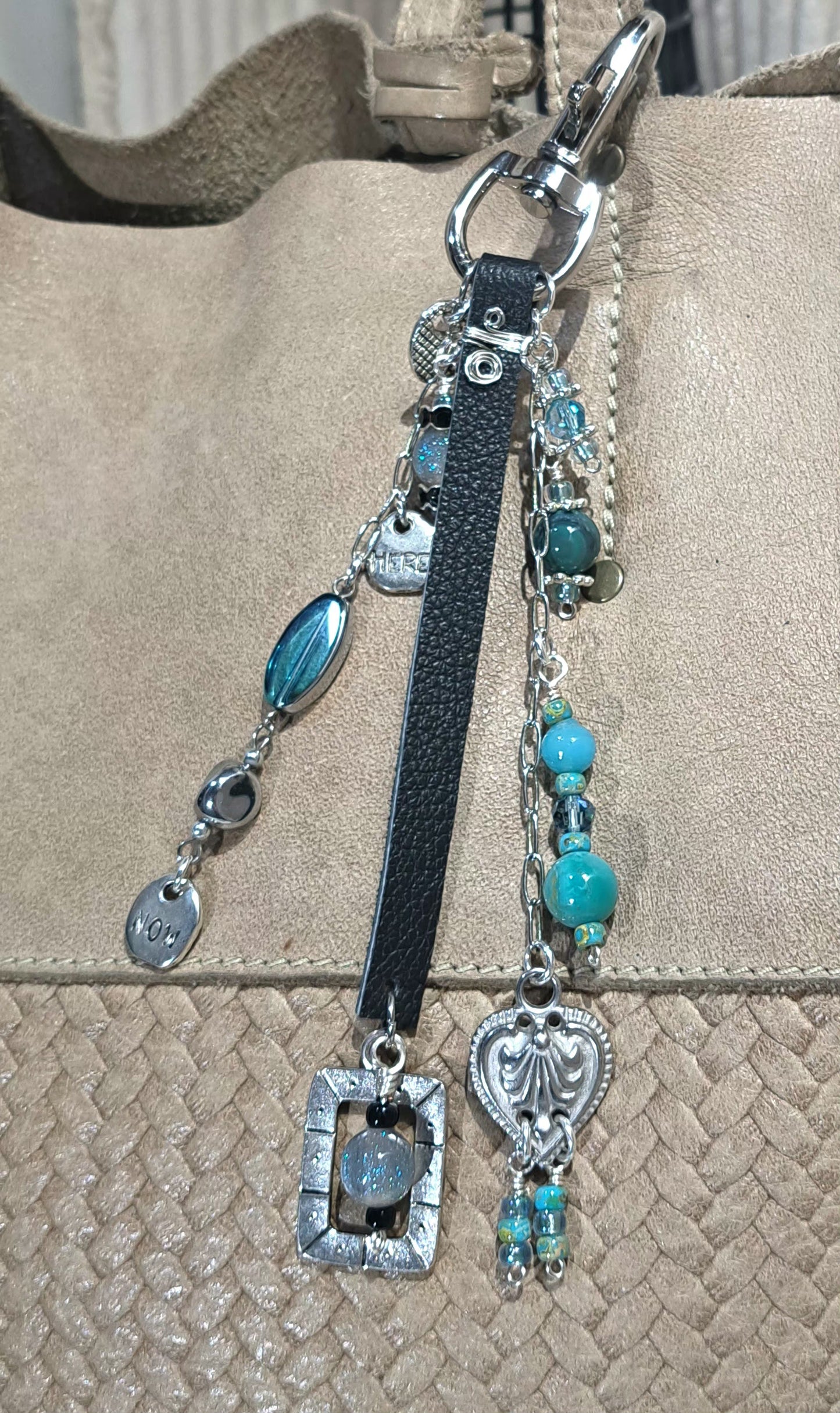 Black leather ,steel and blue resin beaded bag charm .