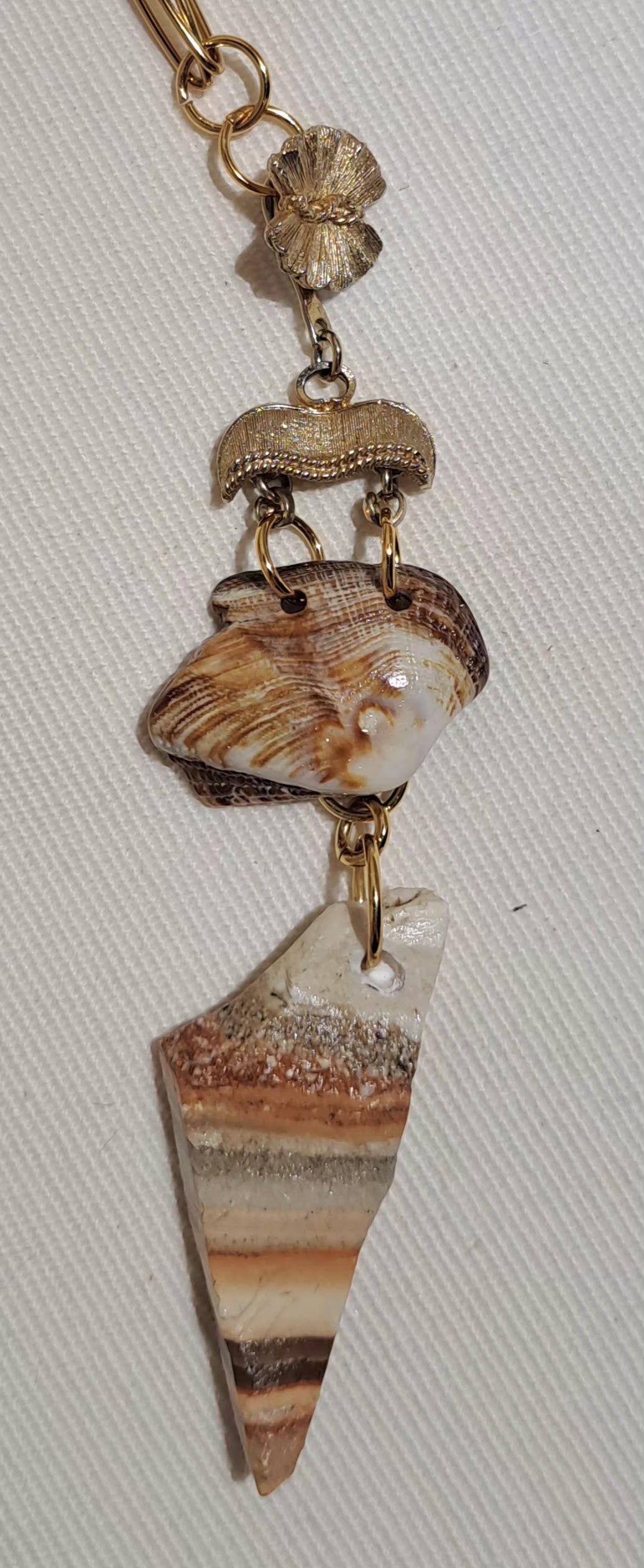 Paperclip chain necklace with vintage brushed gold clasp featuring sea shell and Caymanite pendant.