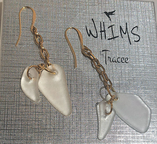 close up of Clear sea glass earrings set on Whims gift box
