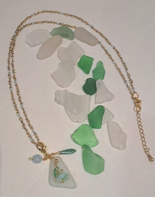 Clear sea glass pendant with striae green and blue sea glass chip a Czech glass leaf and pale blue jade bead.