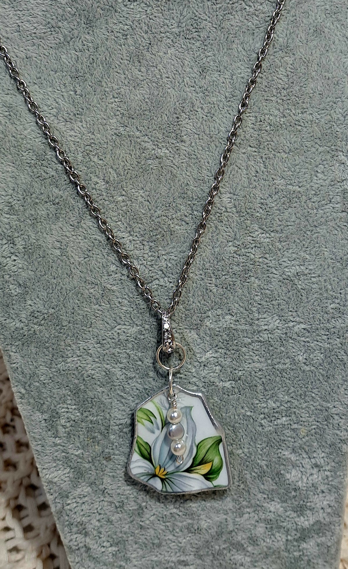 Broken china Trillium floral pendant from sparkling bail.