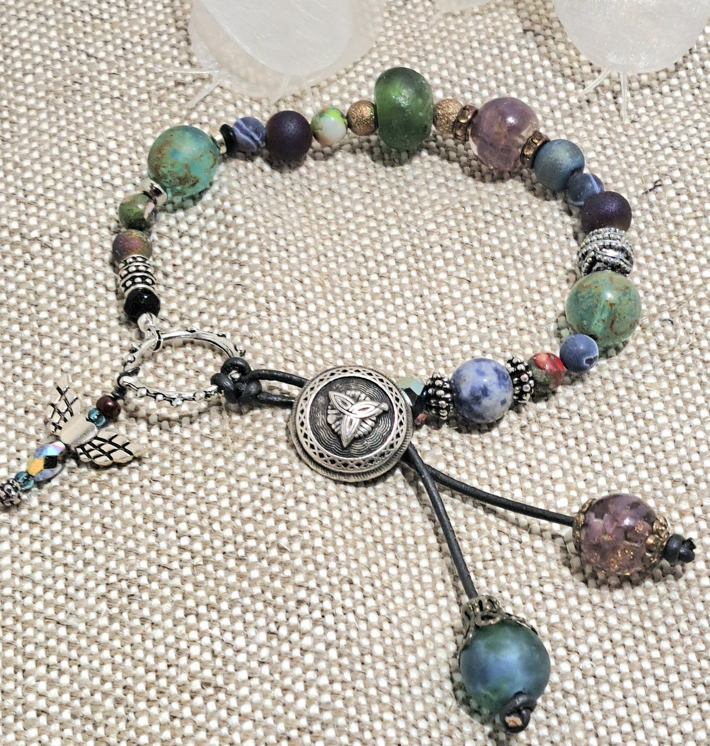 Ladies Celtic knot button and mixed bead bracelet with a bohemian flare and angel charm.