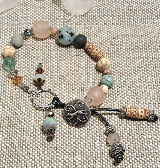 Ladies Mixed bead dog button on bracelet with leather toggle ends.