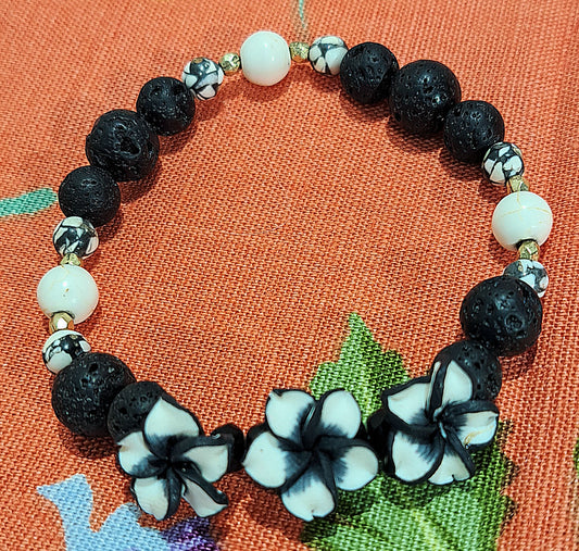 Ladies Stretch Black Lava bead and Ivory Howlite bracelet with a trio of Polymer Flowers