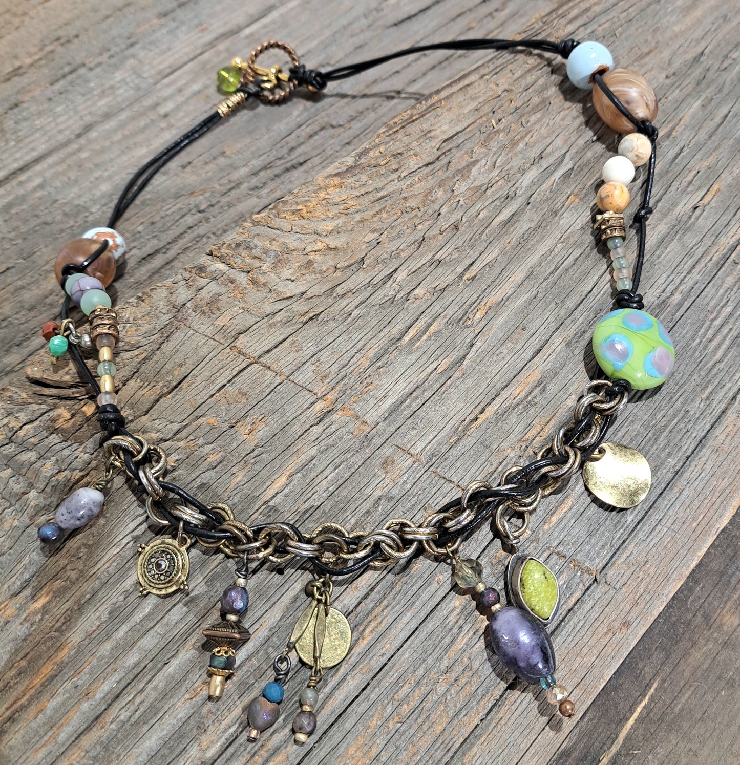 Black leather and mixed bead Bohemian inspired charm necklace.
