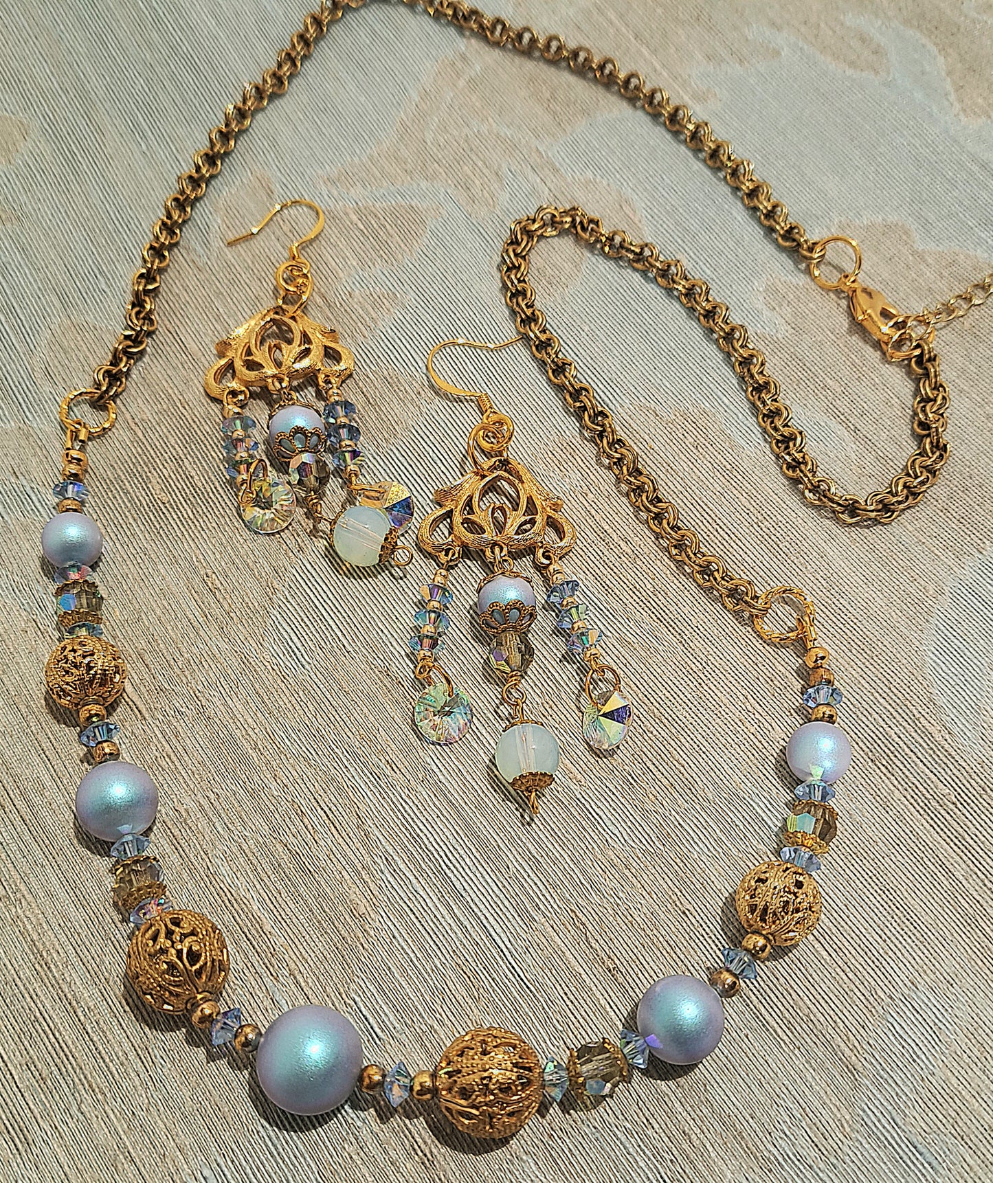 Ladies Swarovski blue pearl and vintage gold necklace and earring set.