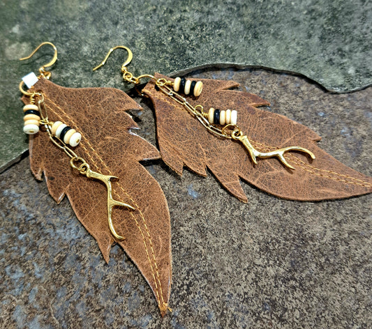 Ladies distressed brown leather leaf earring with gold branch.