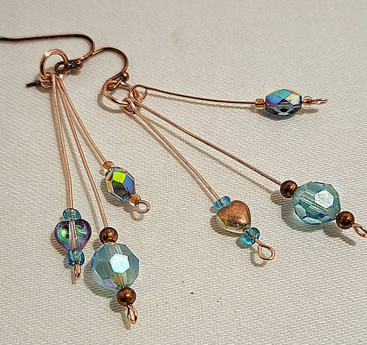 Ladies rose gold with blue cut glass tri-dangle earrings.