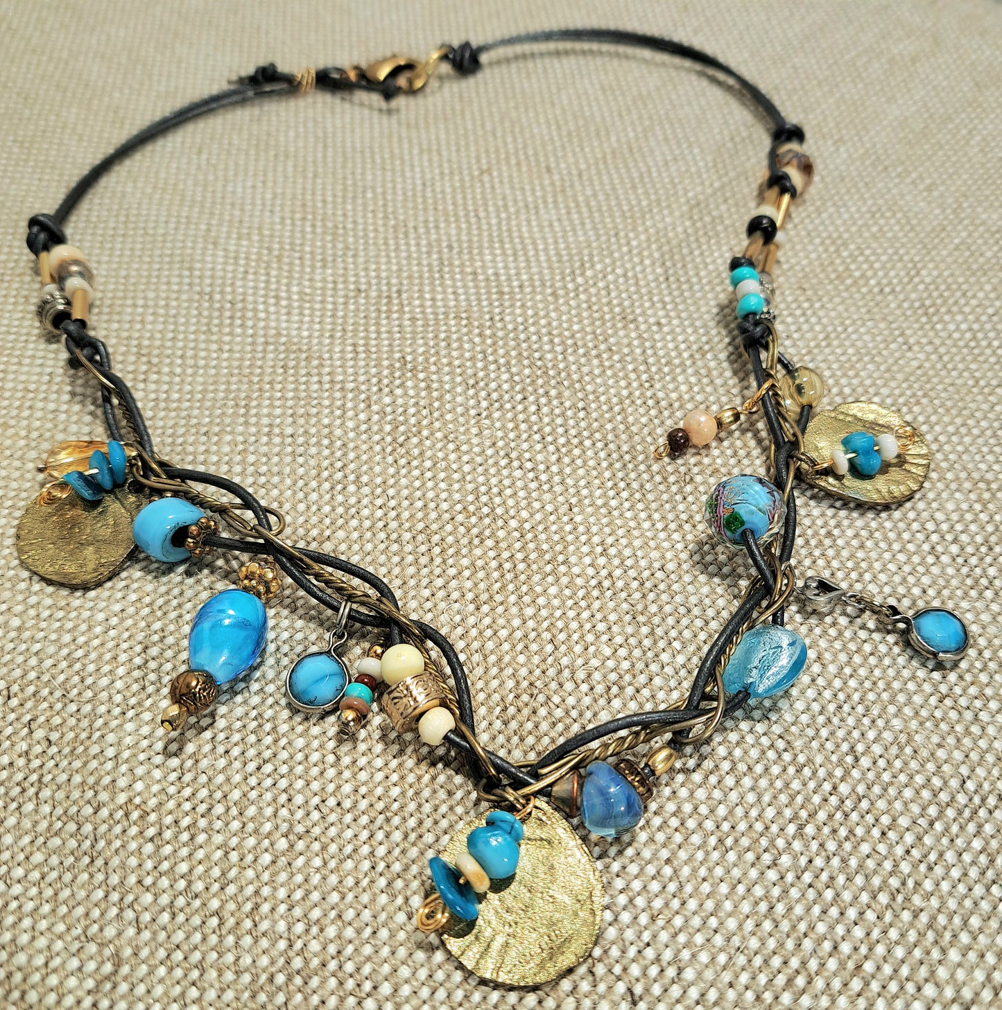 Ladies grey leather necklace with Brass chain links and mixed blue beads.