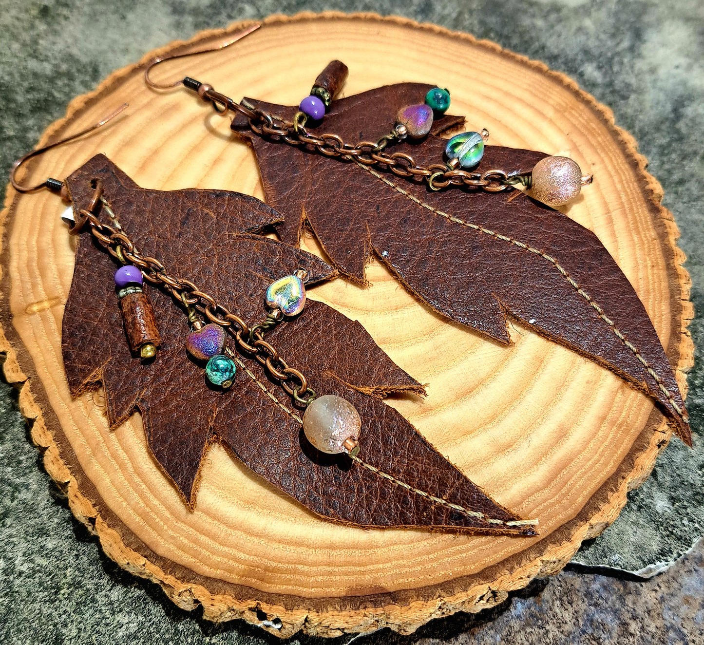 Ladies brown stitched leather leaf earrings with copper chain and mixed bead accents.