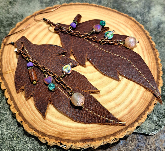 Ladies brown stitched leather leaf earrings with copper chain and mixed bead accents.