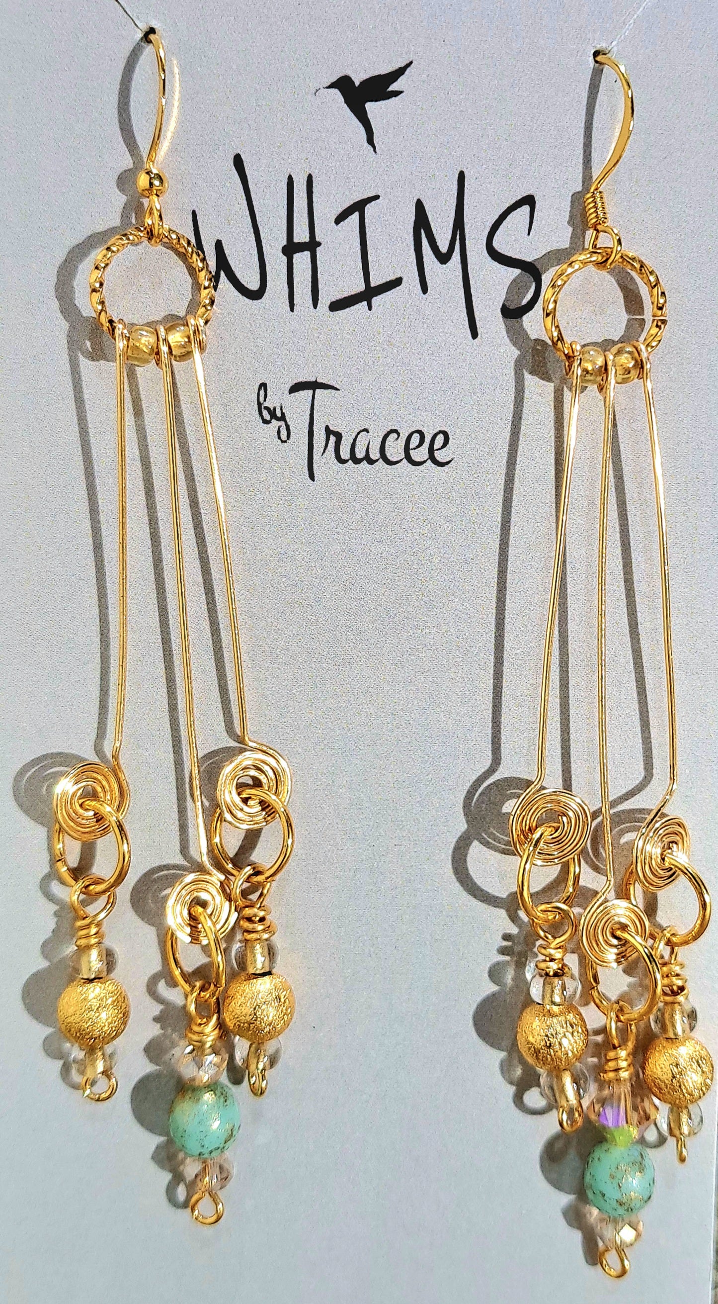 Ladies 3 stem gold swirl dangles with gold flecked bead accents.