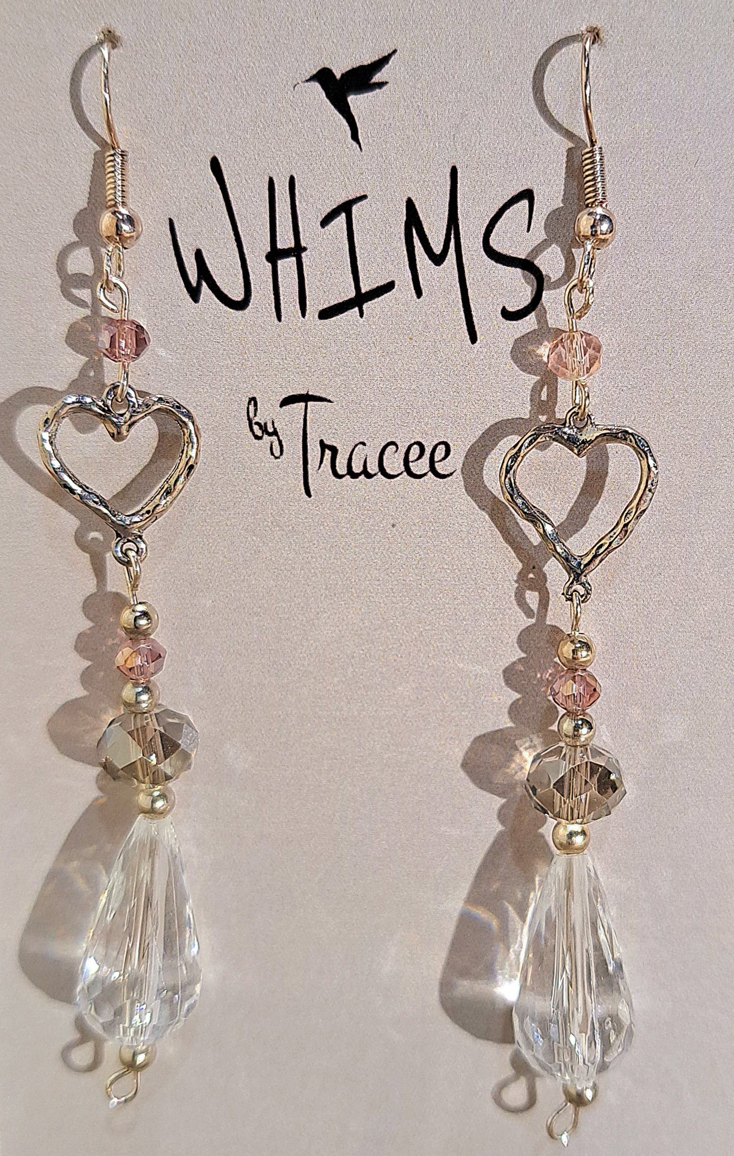 Ladies tear drop crystal and etched heart dangle earrings on silver plate.