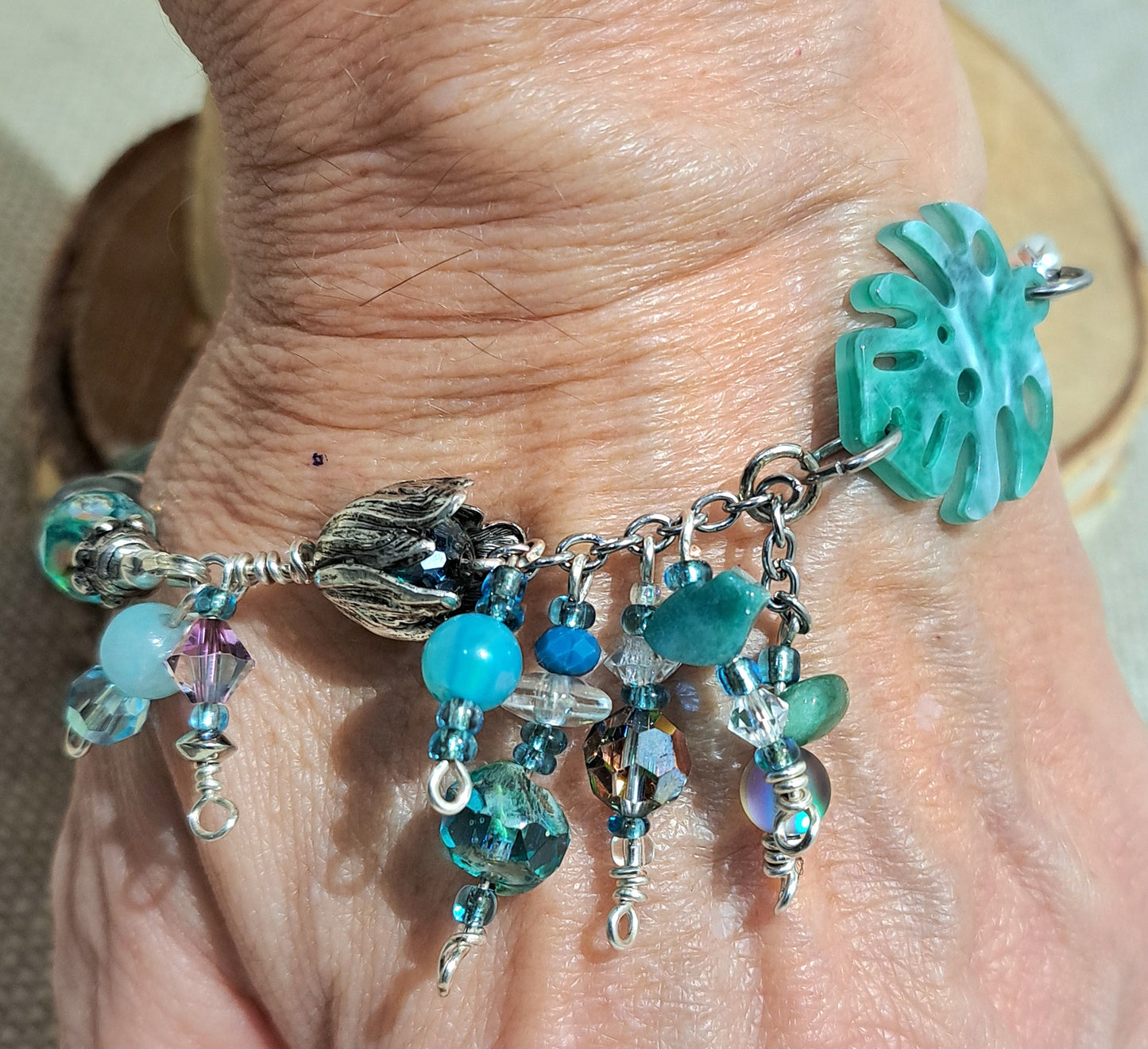 Ladies  bracelet of blue/green recycled African glass and leaf focal.