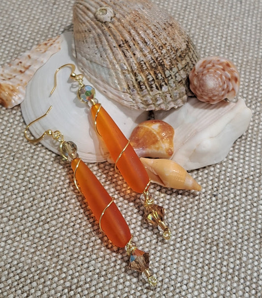 Ladies orange sea glass wire wrapped earrings.