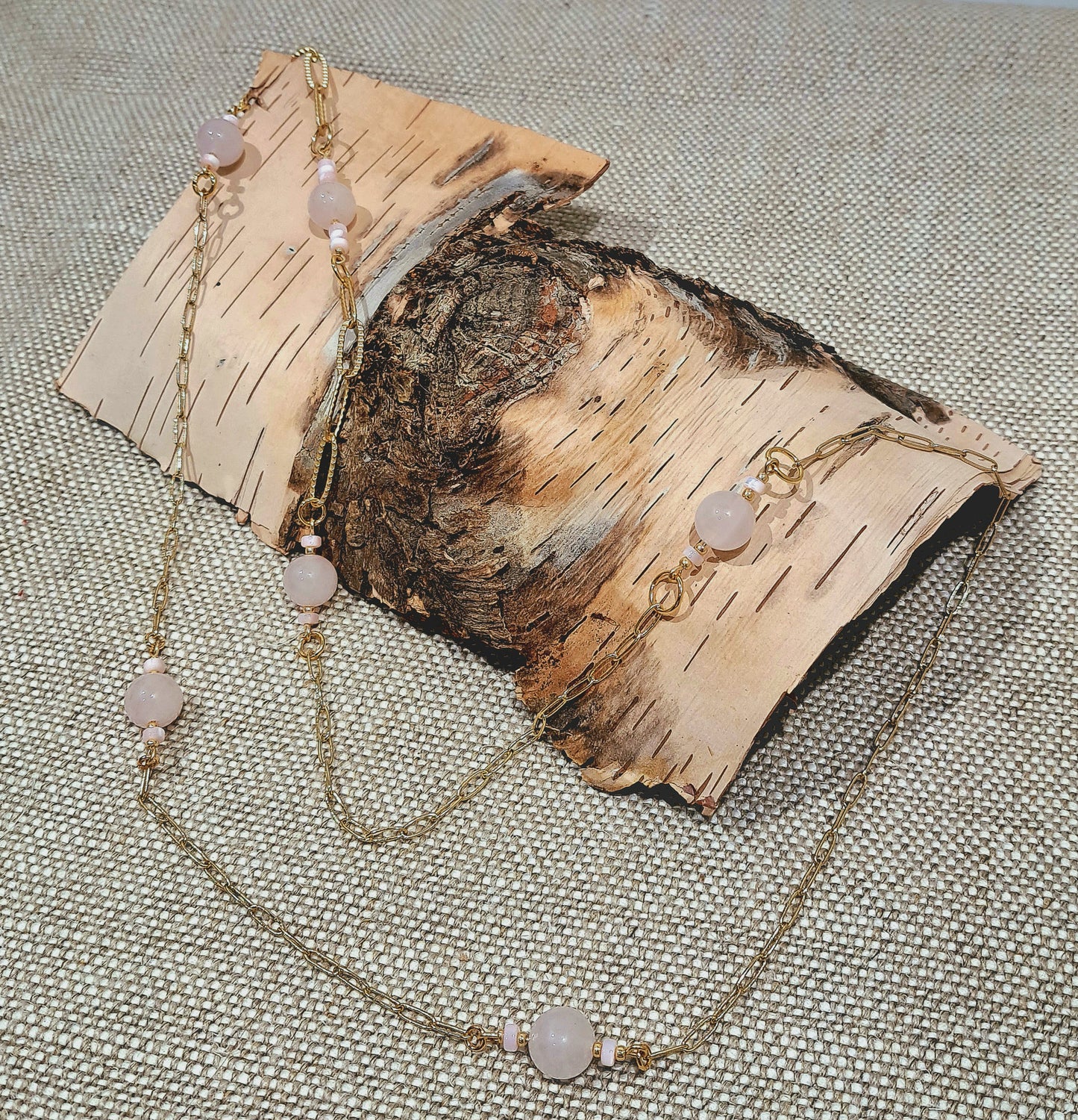 Ladies  necklace with Rose Quartz beads suspended amongst gold plated paperclip style chain.