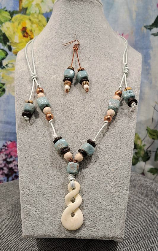 Ladies Maori Love twist design pendant  and blue terra cotta adjustable necklace.