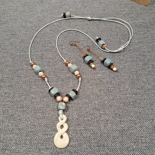 Ladies Maori Love twist design pendant  and blue terra cotta adjustable necklace.