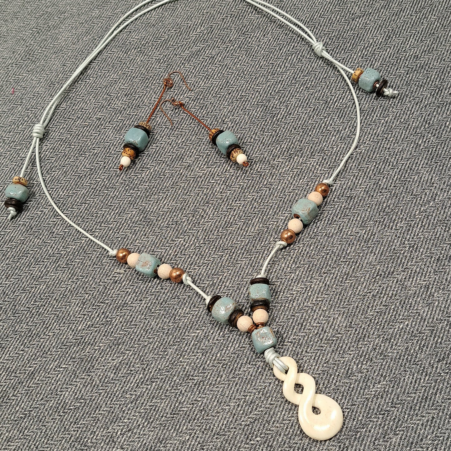 Ladies Maori Love twist design pendant  and blue terra cotta adjustable necklace.