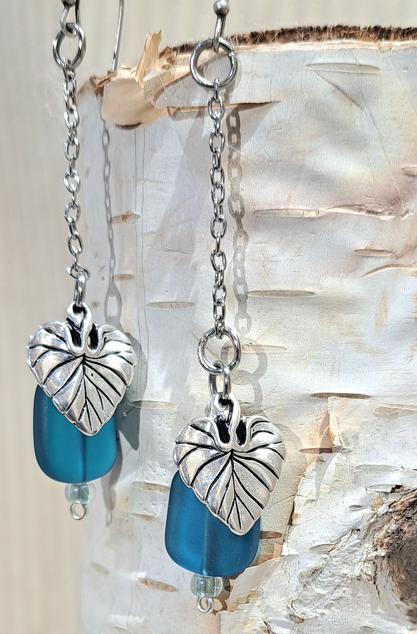 Stainless Steel chain dangle earrings with blue  glass and steel leaf charm.