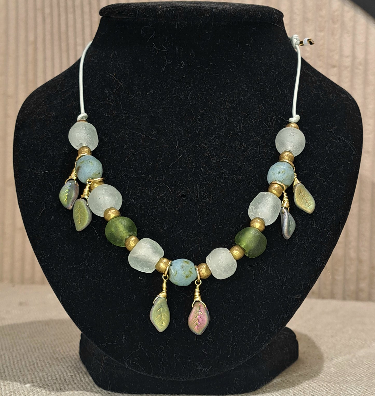 Ladies African recycled glass large bead necklace strung with pale sea green leather adjustable strap.