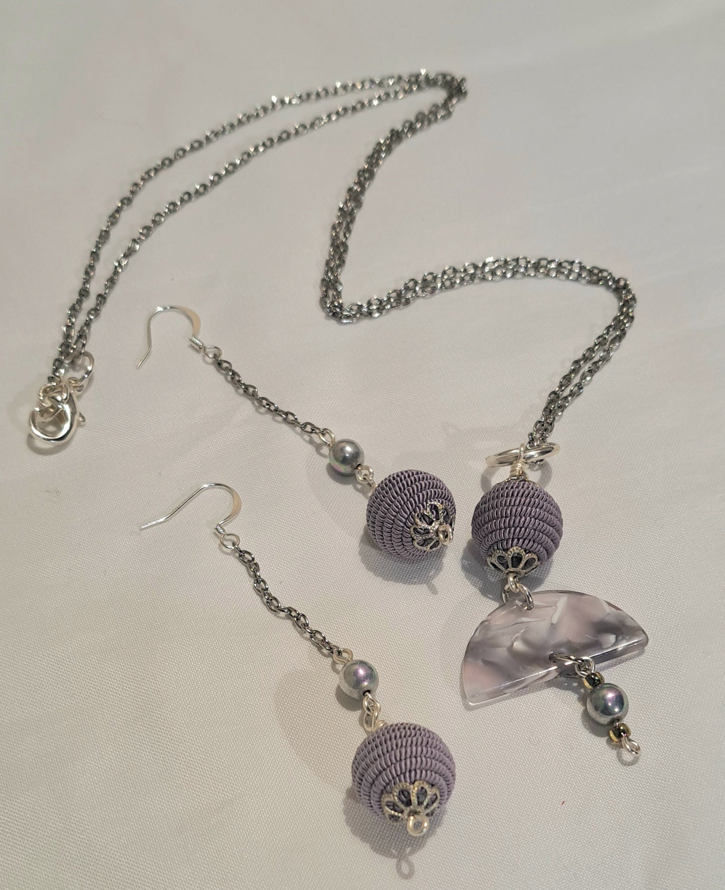 Mauve earring and necklace set of braided cord bead and acetate and pearl focal.