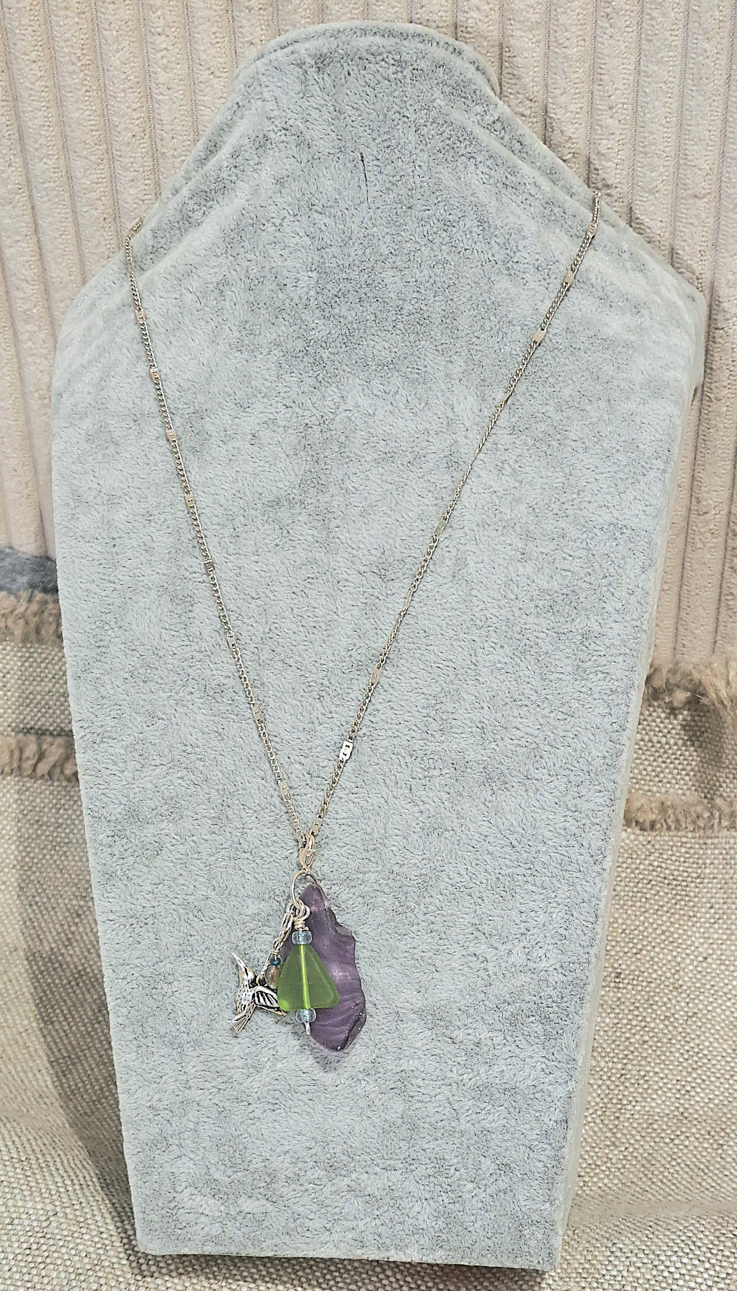 Hummingbird Charm  and Purple strie Sea Glass necklace.