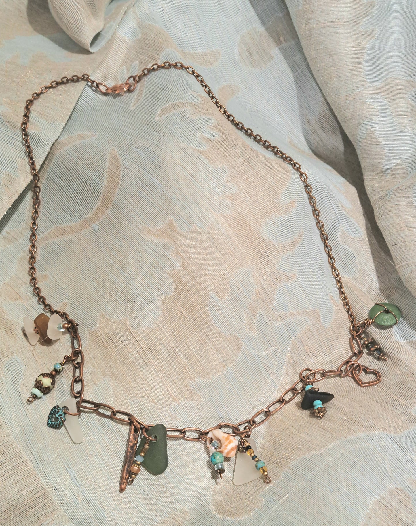 Whimsical Copper chain necklace adored with multiple sea glass pieces.